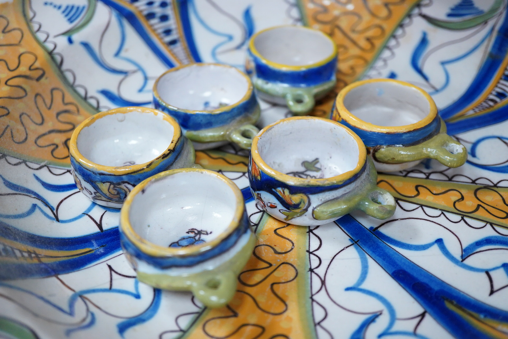 Two 18th century Delft polychrome chargers, five other faience chargers, a rectangular 19th century French faience dish and a blue and white letter rack